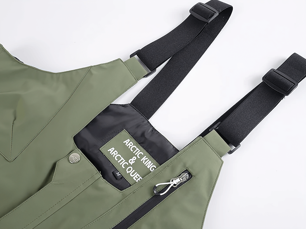 Green waterproof snowboard bib pants with adjustable straps and zippered pocket, perfect for winter skiing or snowboarding activities.