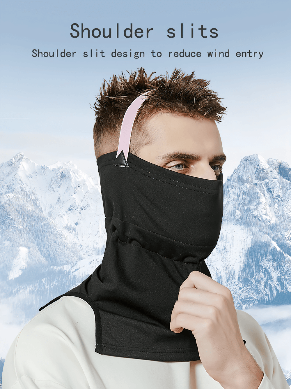 Person wearing black thermal face and neck guard for skiing with shoulder slits against snowy mountain backdrop.