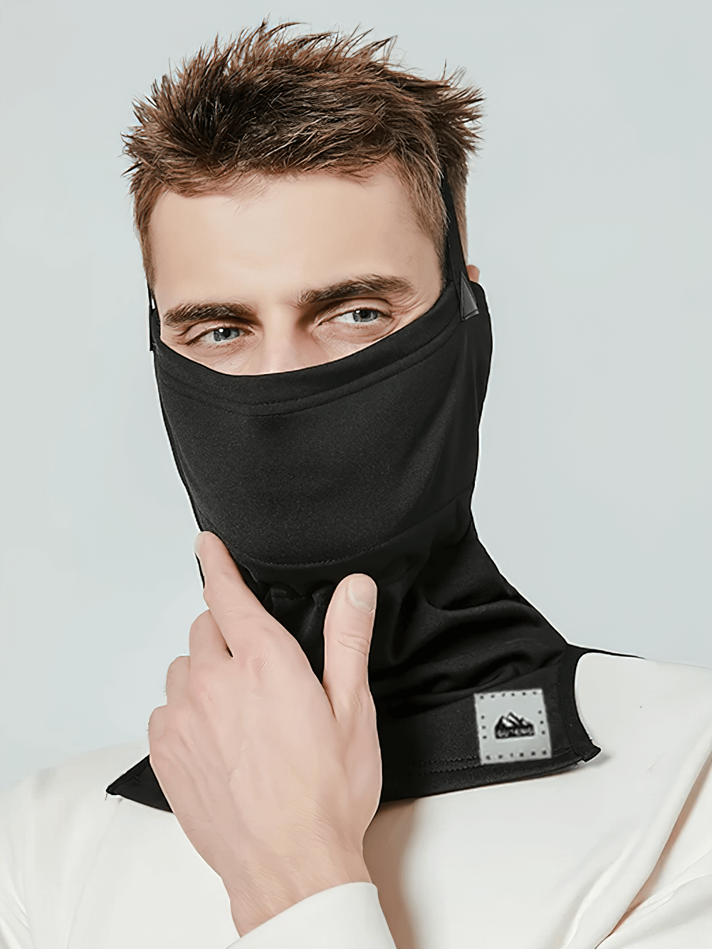 Man wearing snowproof thermal face and neck guard for skiing and snowboarding, black windproof mask, SF2491.