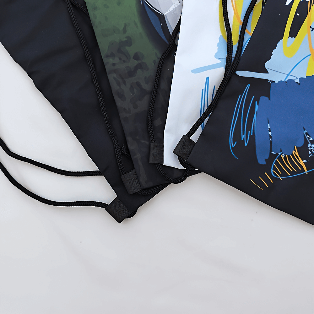 Close-up of colorful polyester drawstring backpacks with abstract designs.