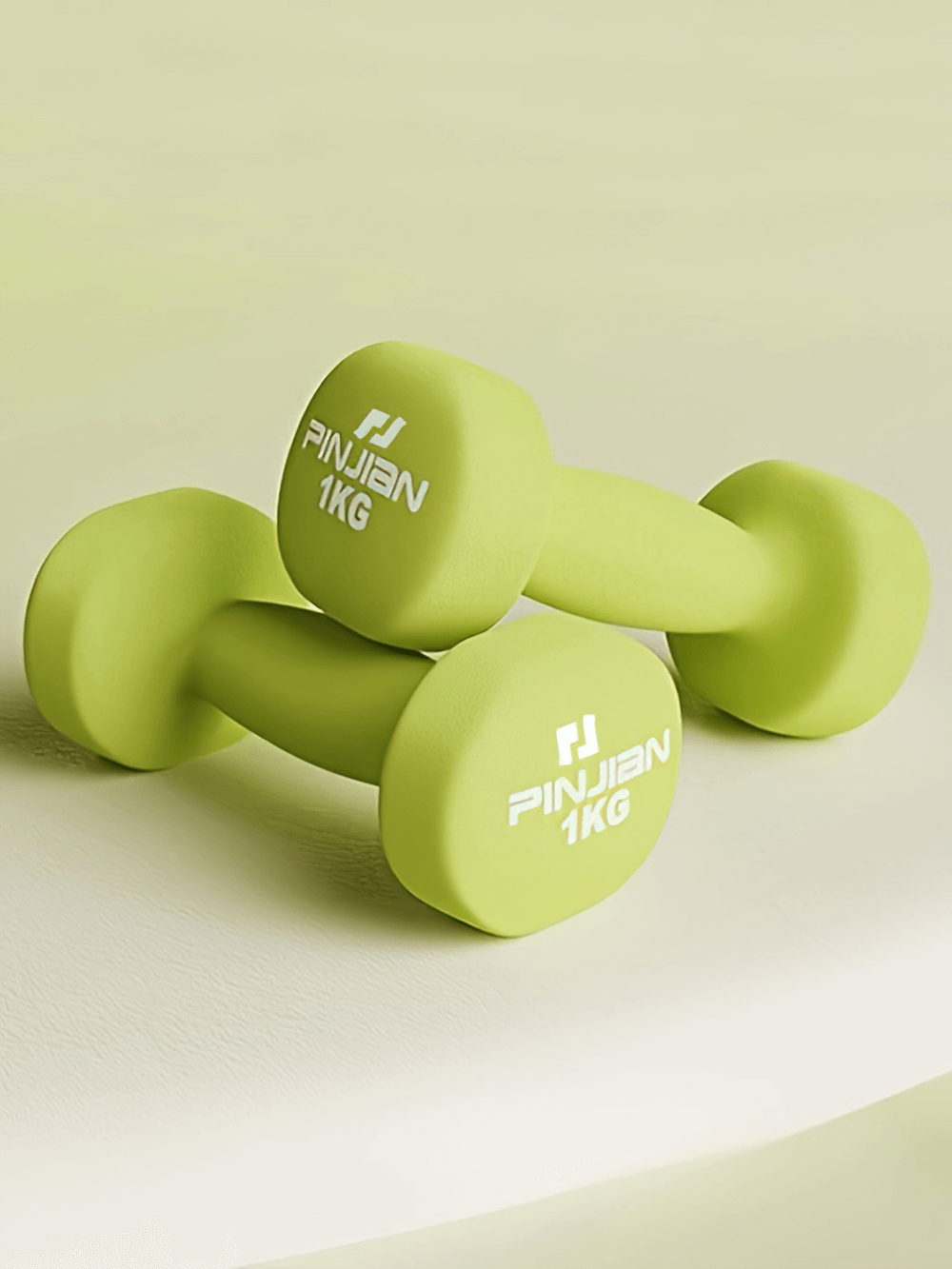 Bright green 1kg soft grip dumbbells on white surface, perfect for safe strength training and enhancing home workouts.