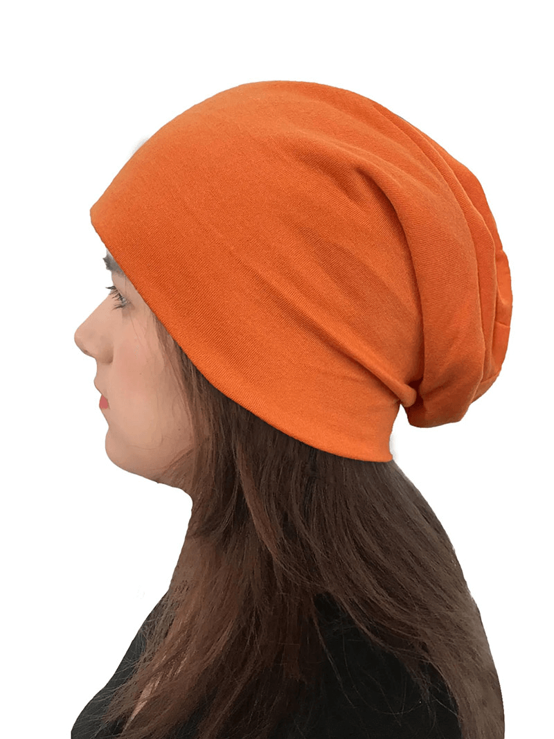 Side view of a person wearing an orange soft lightweight running beanie, perfect for casual outings and sports. Unisex and made of cotton.