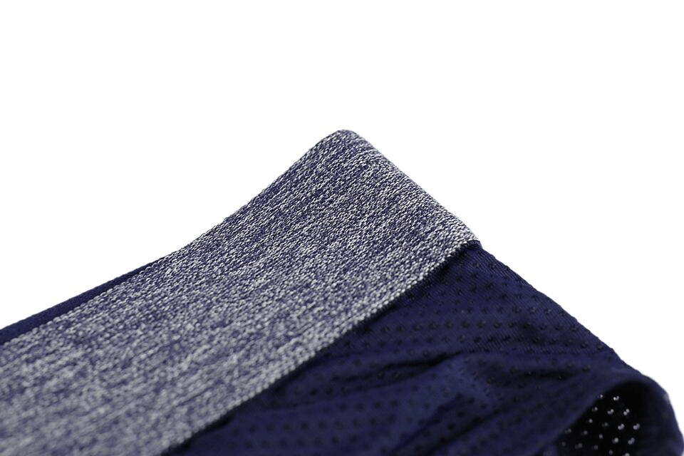 Close-up of soft nylon men's underwear waistband in navy and gray, showcasing breathable fabric and sleek design. Ideal for comfort and support.