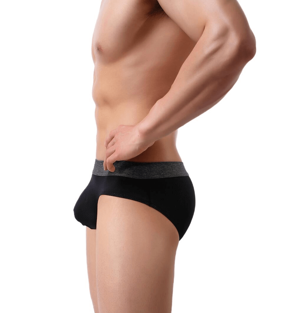 Side view of a model wearing soft nylon men's underwear, showcasing sleek black briefs, breathable with elastic waistband, perfect for active lifestyle.
