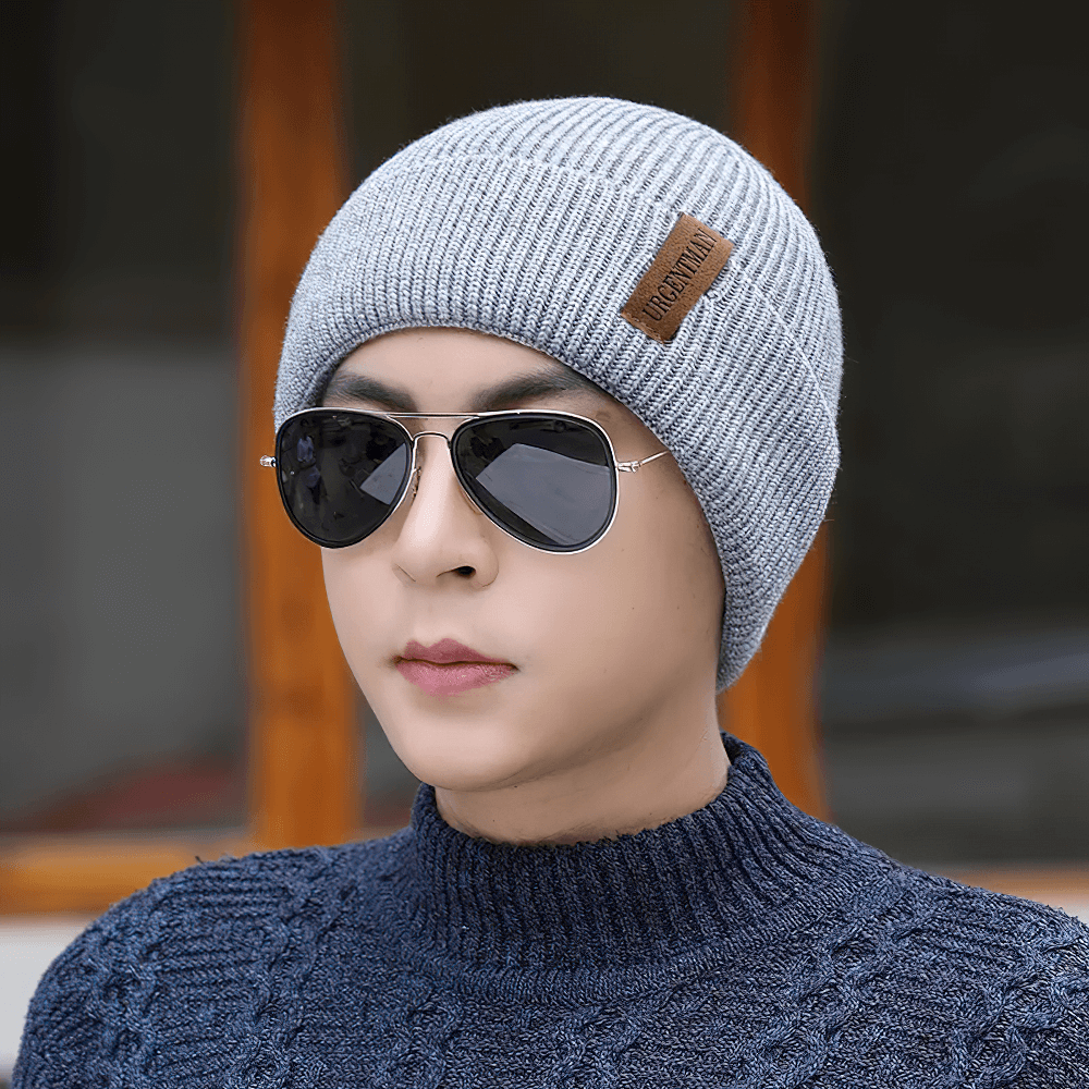 Stylish ribbed knit beanie with fleece lining worn by person in sunglasses, perfect for chilly outdoor activities.