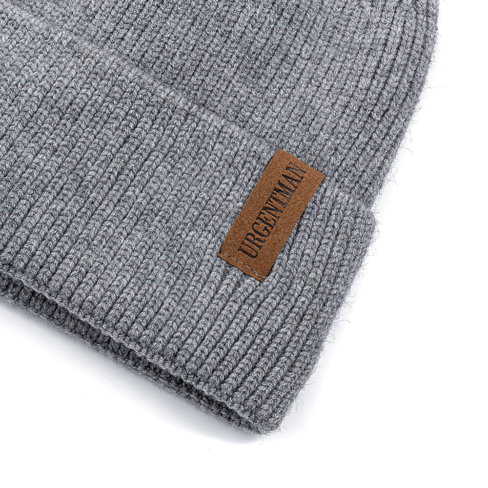 Alt Tag: Soft ribbed knit beanie with fleece lining in grey, showing detail of warm texture and stylish leather patch.