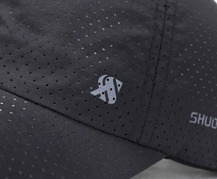 Close-up of solid color breathable mesh baseball cap with a visible design, showcasing the ventilation and stylish texture.