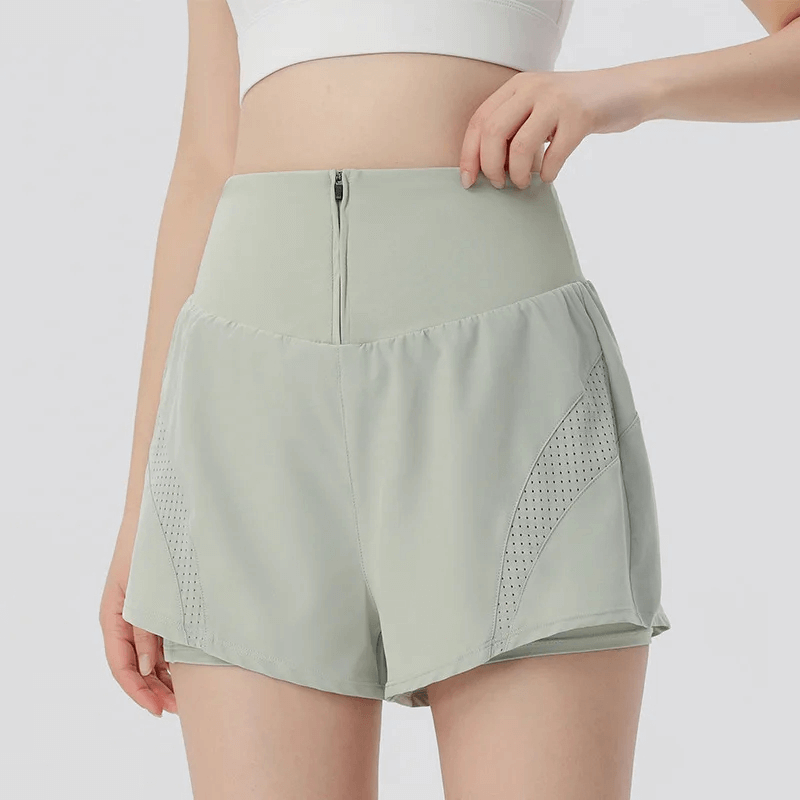 Woman wearing solid color breathable mesh gym shorts with side pockets for workouts, style SF2230