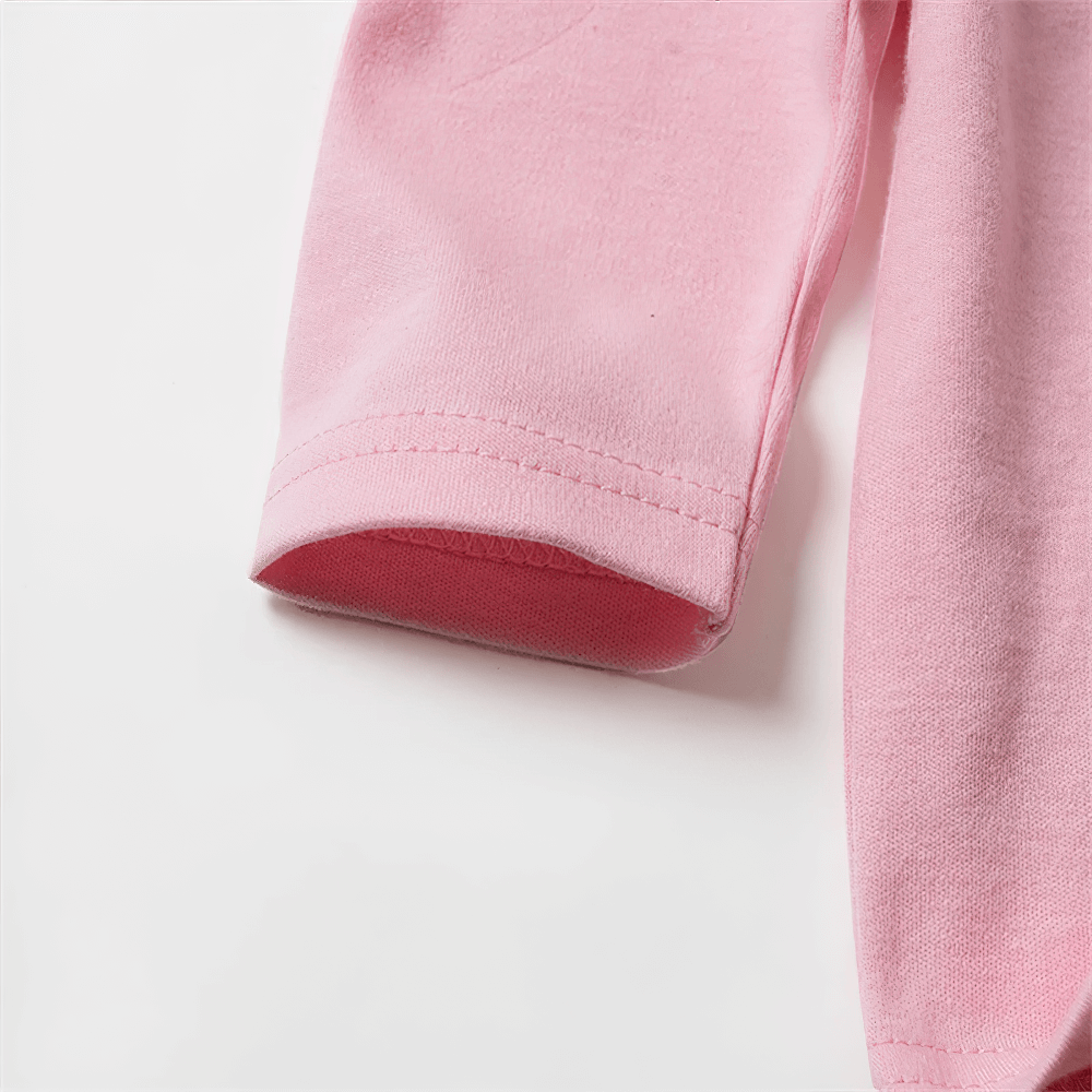 Close-up of a pink long-sleeve, 100% cotton top, showcasing fine stitching and soft fabric, perfect for versatile, stylish casual wear.