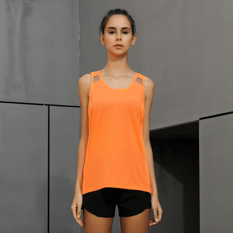 Woman wearing orange loose tank top, perfect for yoga and running. Ideal for active lifestyles with breathable, quick-drying fabric.