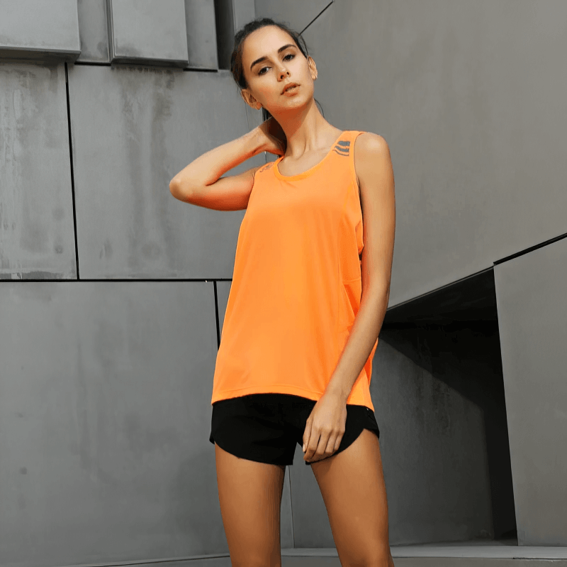 Woman wearing orange solid loose tank top for running and fitness