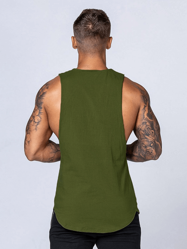 Back view of a man wearing a solid olive green cotton fitness tank top for men, showcasing athletic build and tattooed arms.
