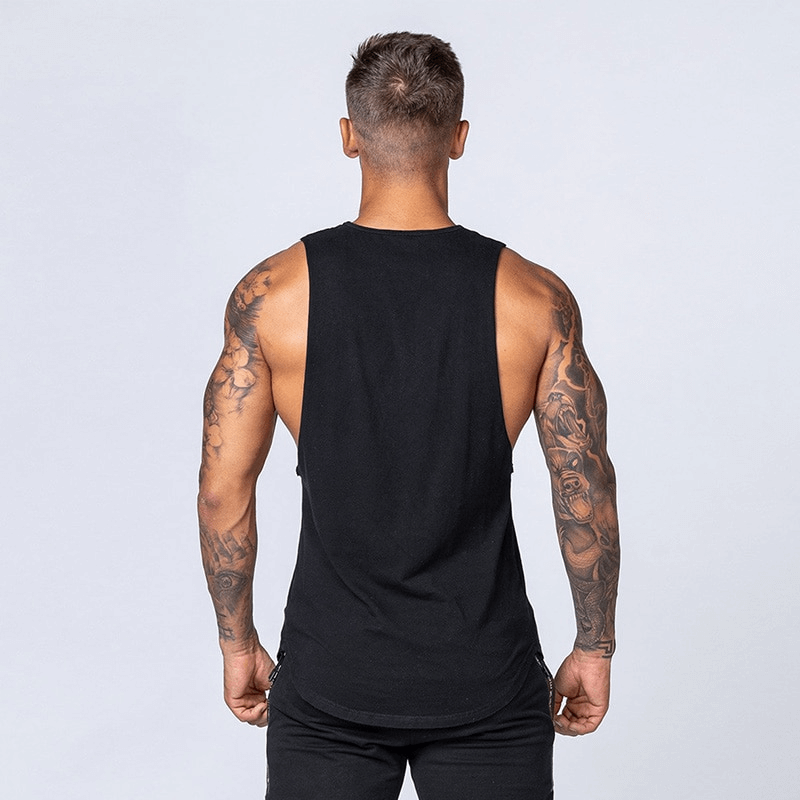 Back view of a man wearing a solid black cotton fitness tank top, showcasing its breathable fabric and comfortable fit, ideal for workouts.