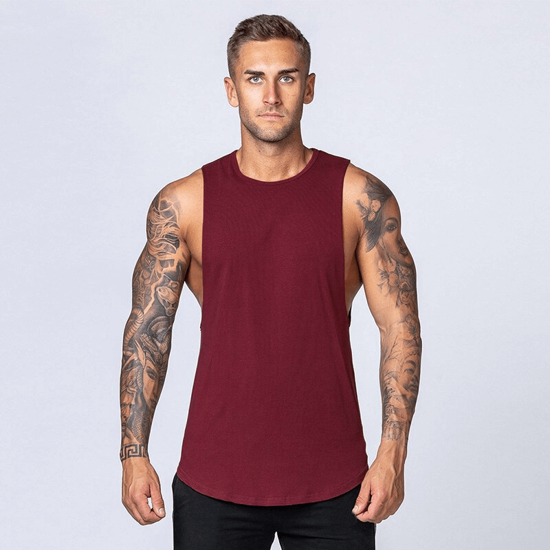 Man wearing solid maroon cotton fitness tank top, ideal for gym workouts, showcasing comfort and mobility with broadcloth fabric. Model SF1491.