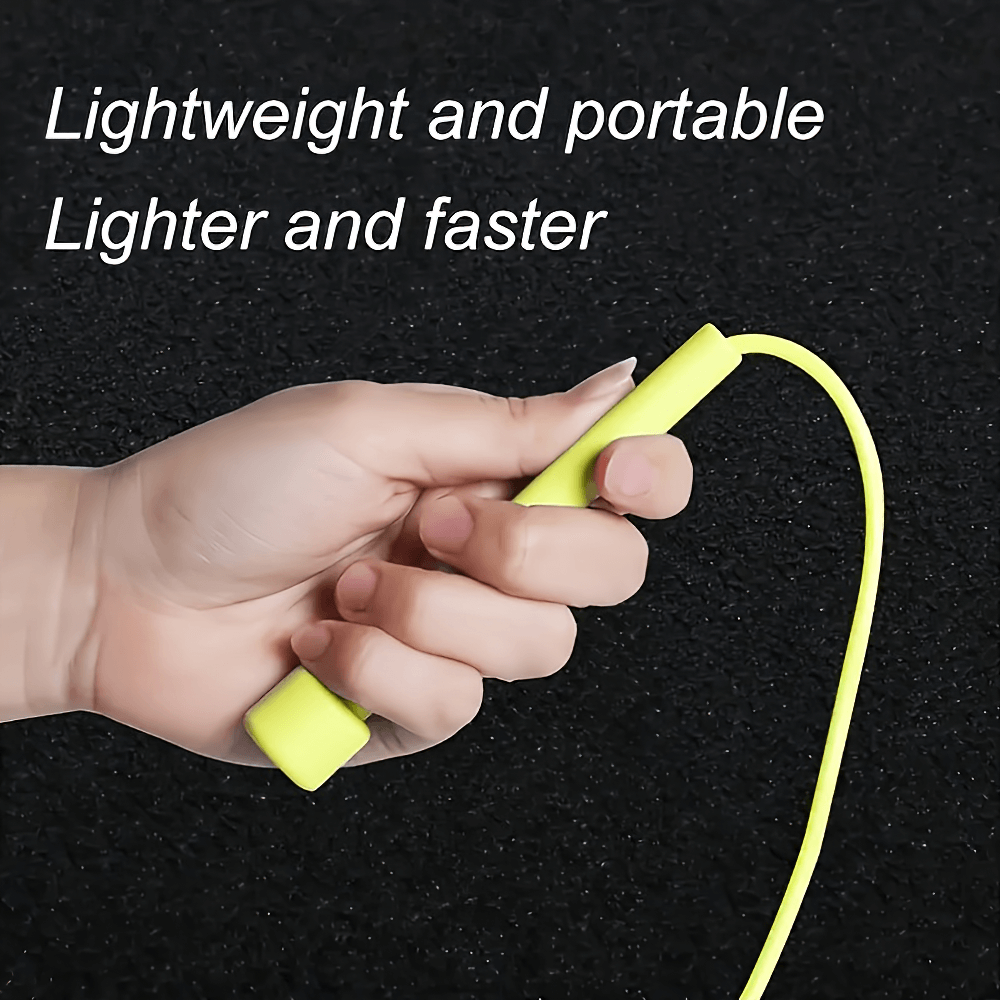 Close-up of a hand holding a neon yellow jump rope with non-slip silicone handle, emphasizing lightweight and portable features.