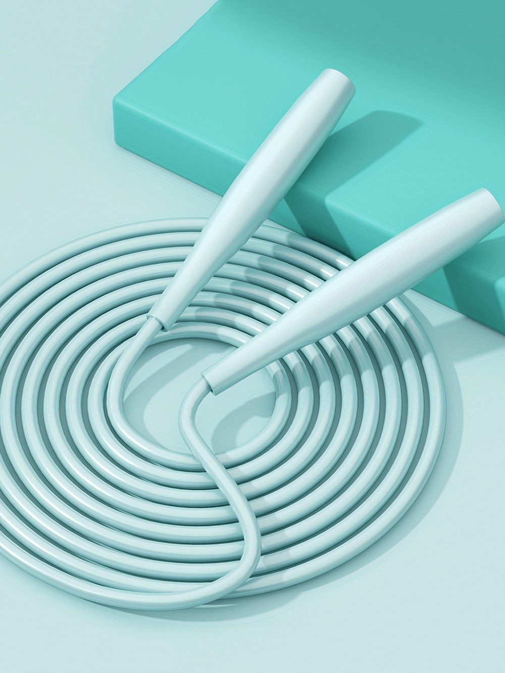 Light blue PVC fitness jump rope coiled on a mat, ideal for rapid speed workouts, tangle-free exercise, and weight loss.