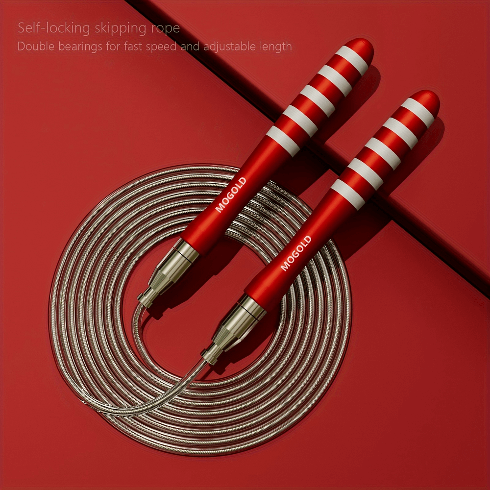 Red and silver steel wire jump rope with ergonomic handles for fast skipping workouts, placed on a red background.