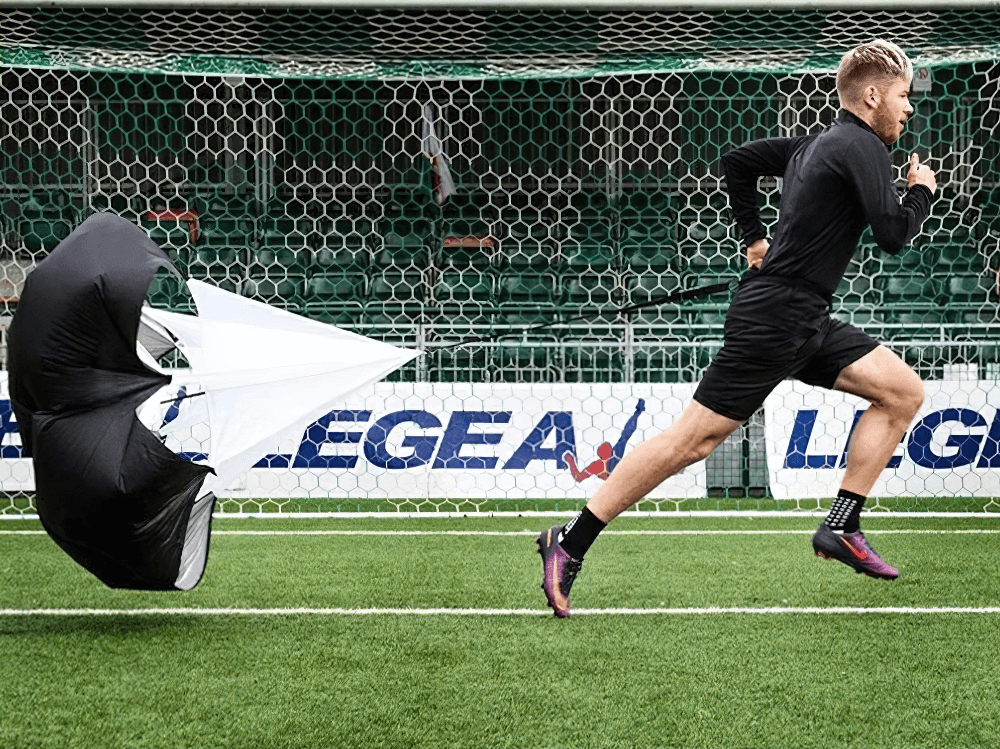 Runner using Speed Training Resistance Parachute SF3215 for improved sprint strength and endurance in agility drills.