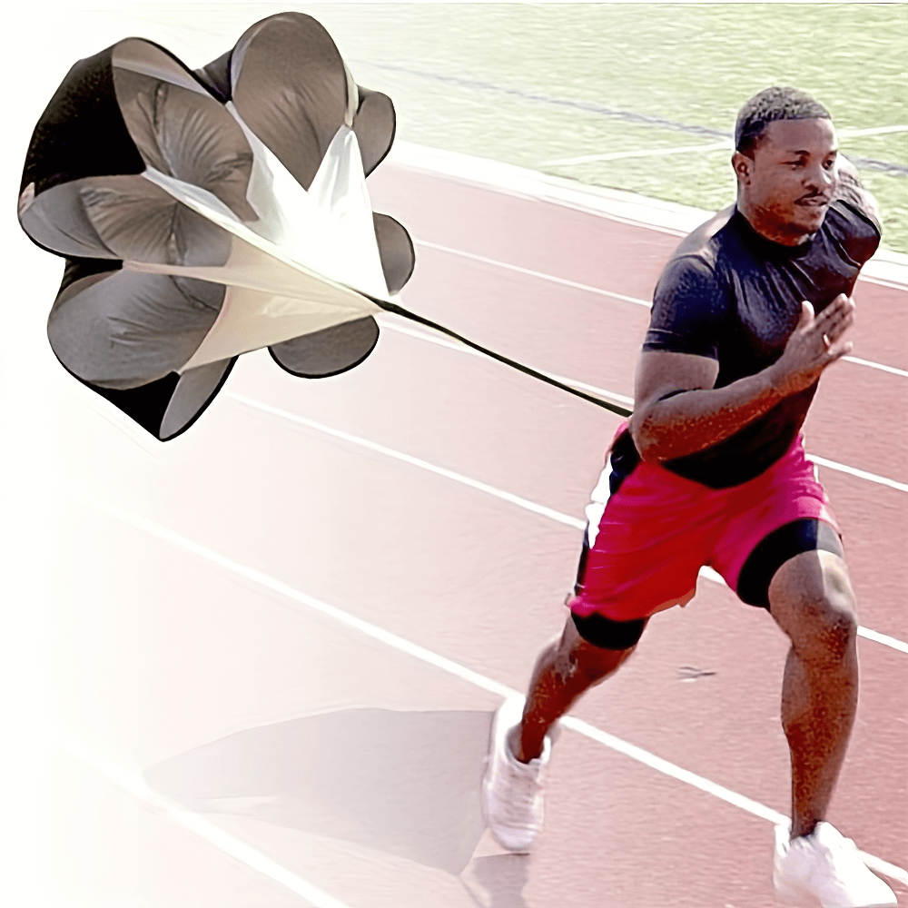 Athlete using speed training resistance parachute on running track for strength, agility, and endurance boost.