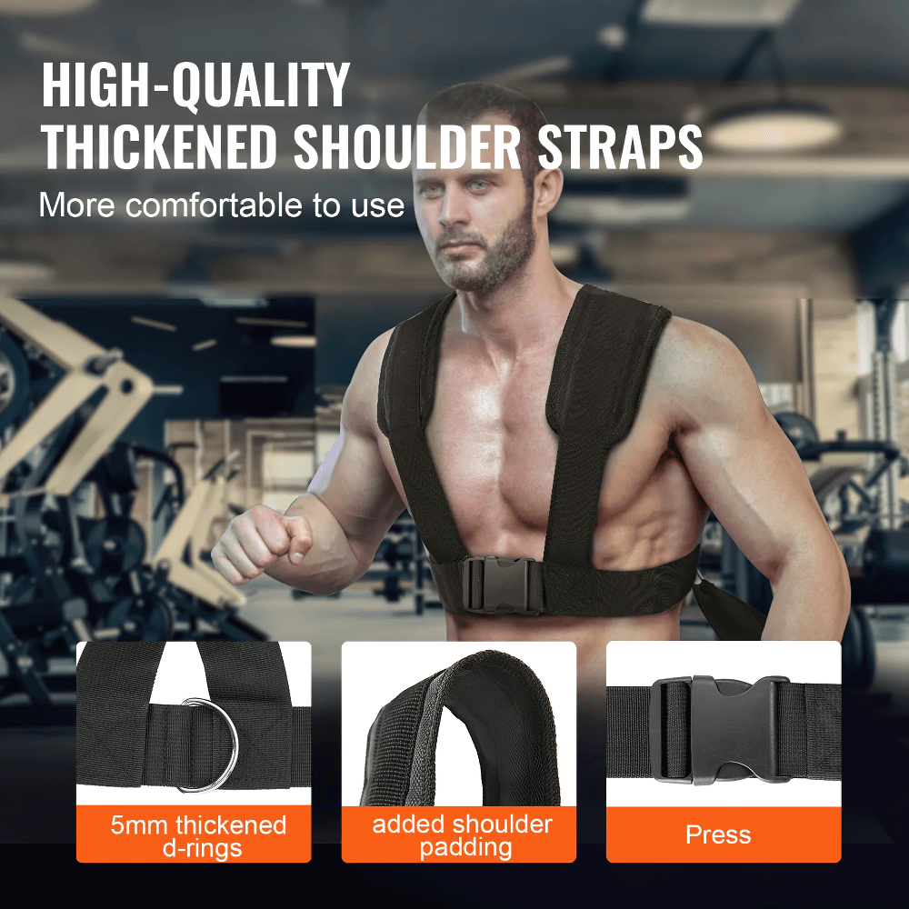 Man wearing a black training harness with thick shoulder straps in a gym setting, highlighting design features for comfort and support.