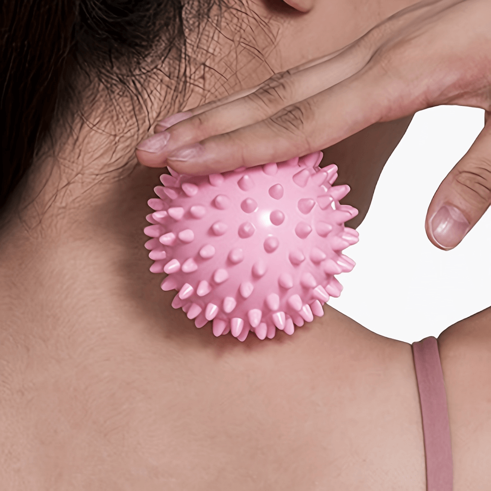 Pink spiky massage ball for neck relief, ideal for deep muscle relaxation and circulation improvement.