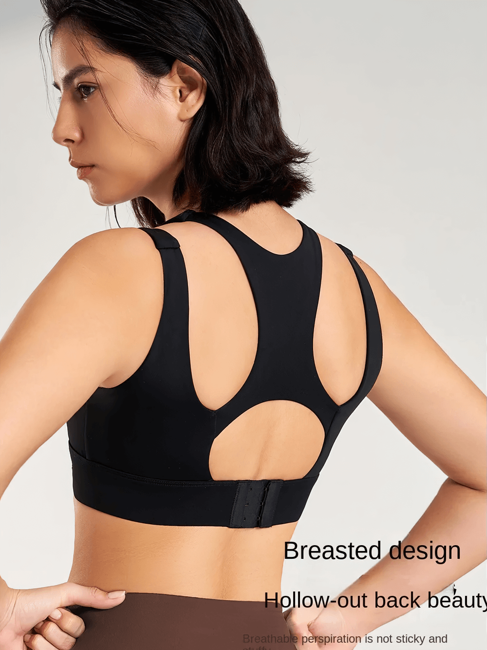 Back view of a black sports bra with hollow design and wide elastic band, perfect for gym workouts.