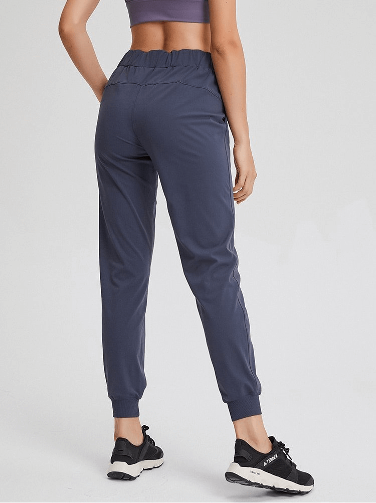 Back view of Sports Breathable Loose Women's Training Pants - SF1420, showcasing adjustable waist and ankle-length fit.