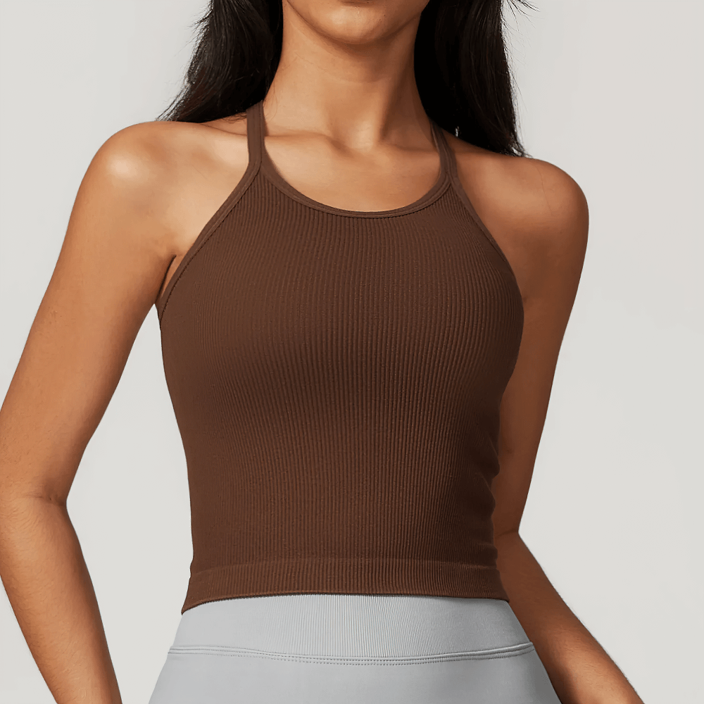 Woman wearing a brown ribbed racerback tank top, perfect for gym wear or casual outings, featuring a sleek, sporty design.