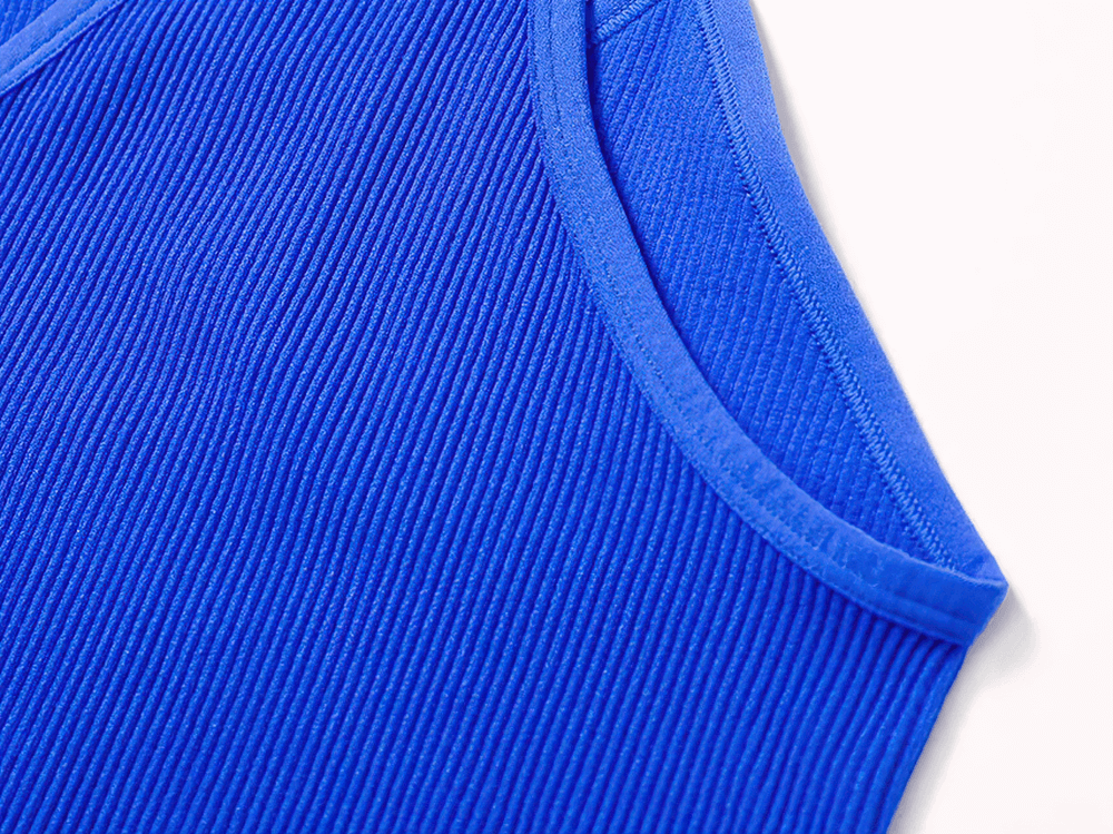 Close-up of blue ribbed racerback tank top fabric, showcasing breathable material for activewear.