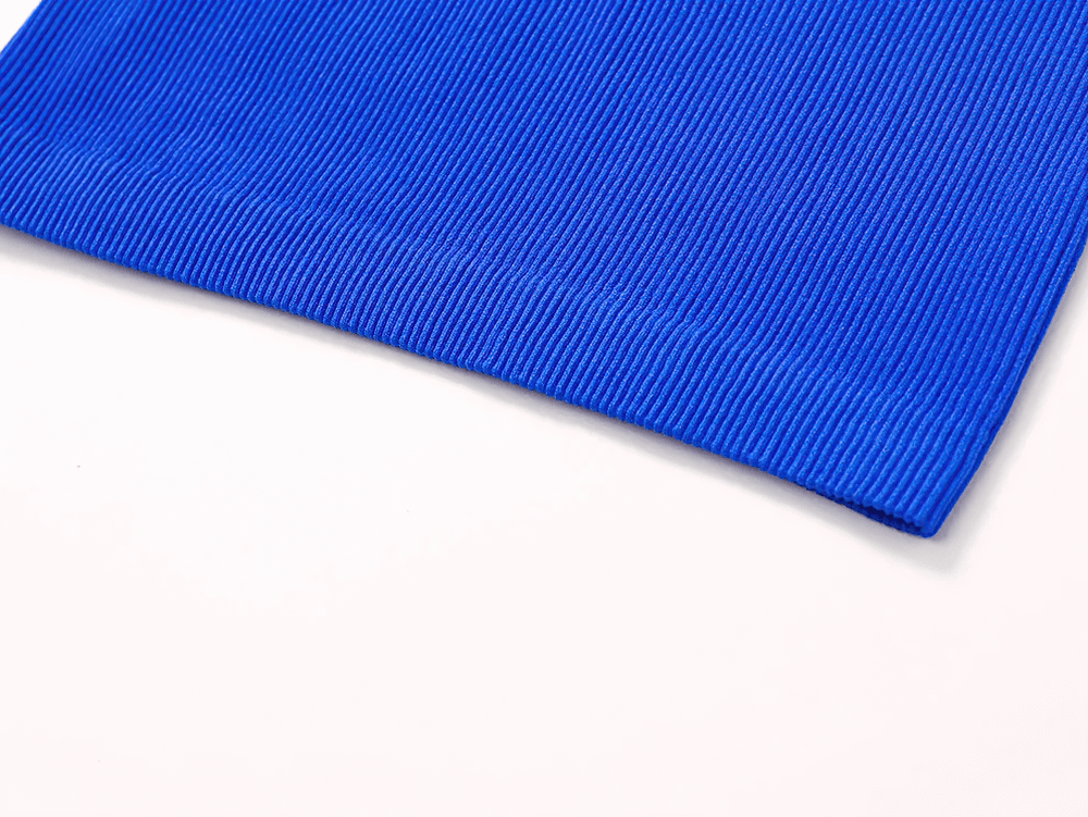 Close-up of blue ribbed fabric from women's breathable racerback tank top for sports and casual wear.