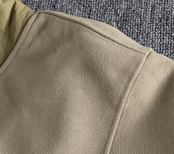 Close-up of a beige sports casual men's hoodie made of cotton, showing the fabric texture and stitch detail.