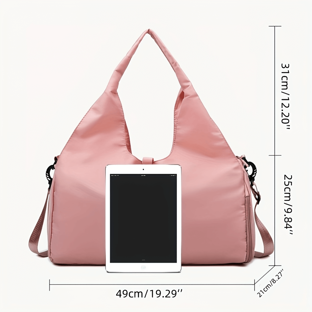 Pink sports duffel bag with shoe compartment, dimensions shown with tablet for size reference, perfect for gym and travel.