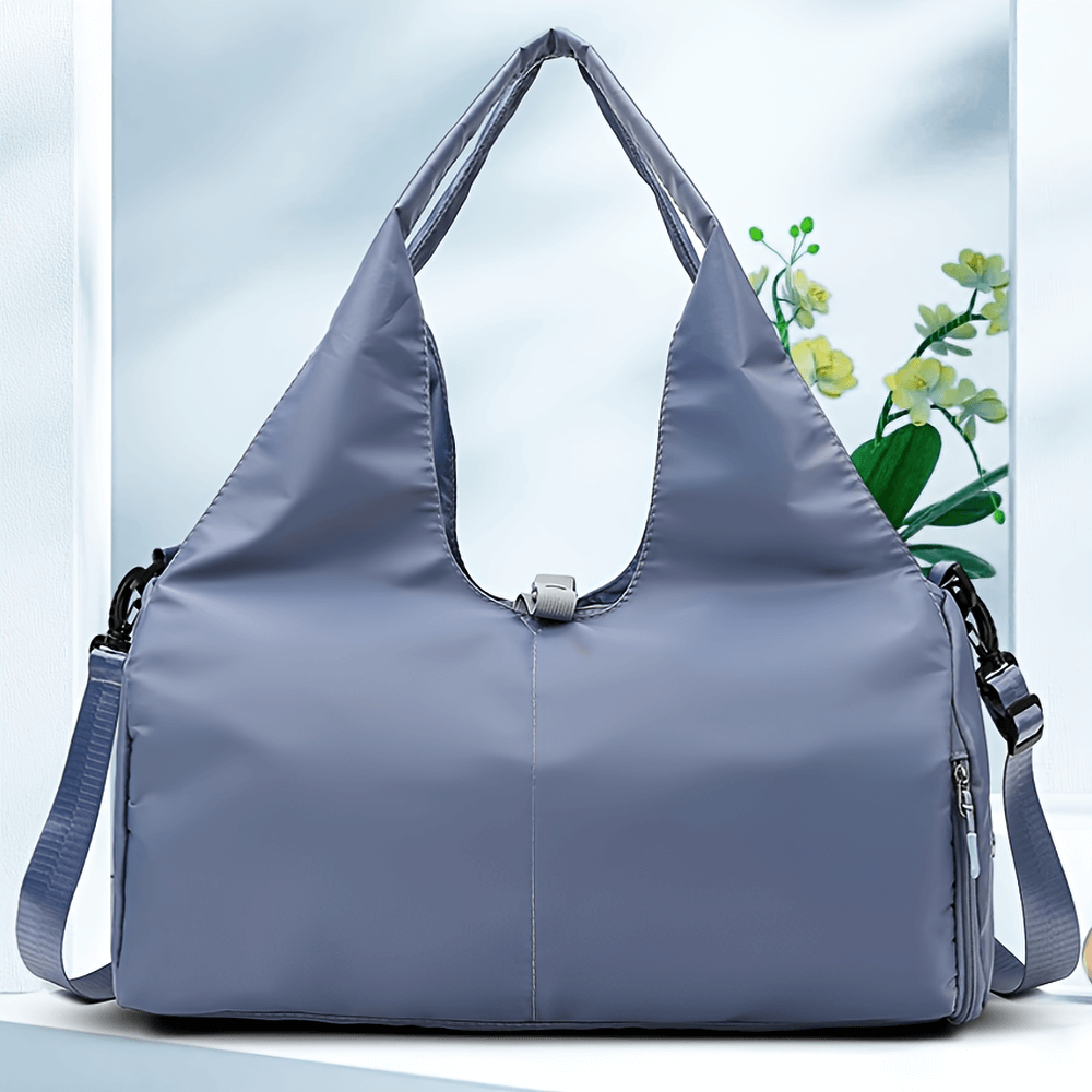 Stylish sports duffel bag with shoe compartment, ideal for gym and travel, in elegant gray color. Versatile and lightweight design.