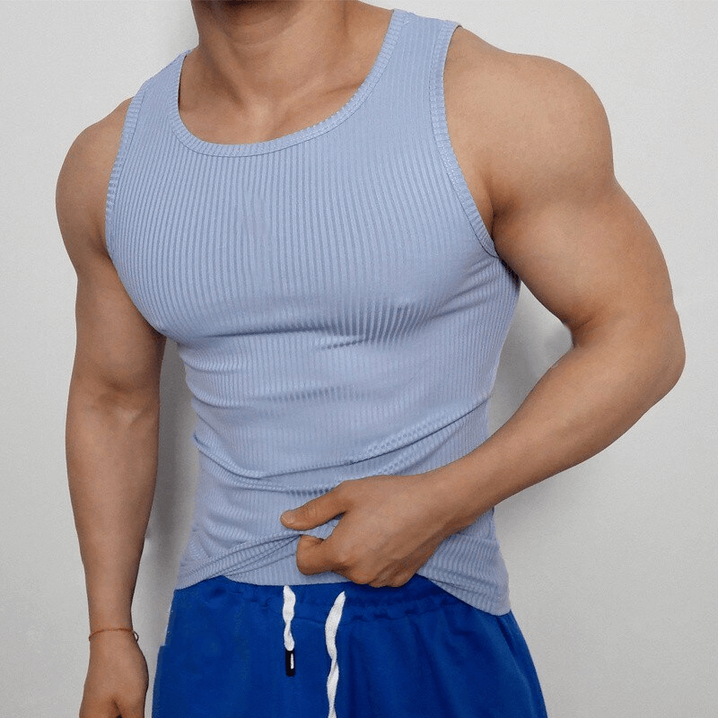 Man wearing a light blue sports elastic breathable tank top for training, showcasing O-neck design and ribbed texture.