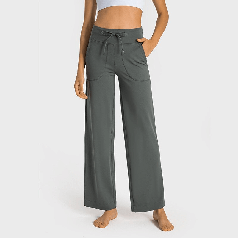 Women's high-waisted wide-leg yoga pants in dark gray, featuring a comfortable elastic waistband and stylish pockets.