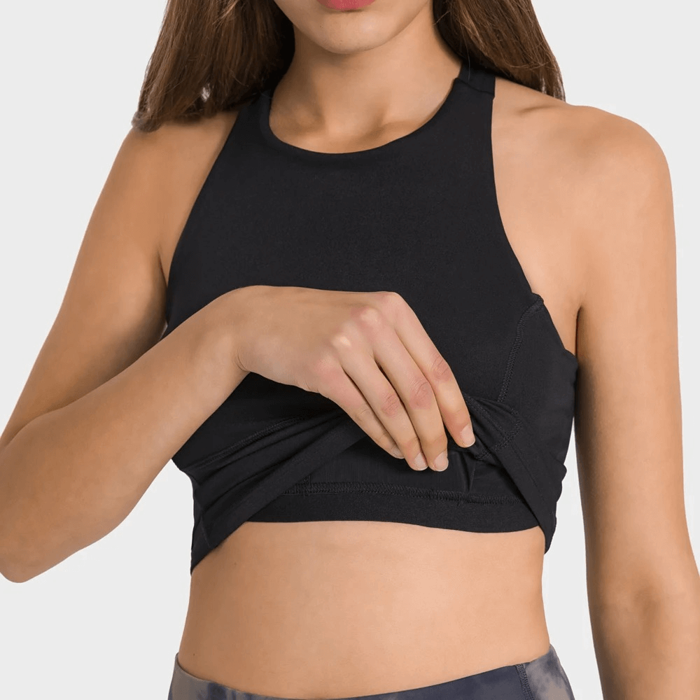 Woman wearing Sports Elastic Tank Top with Built-in Bra, showing breathable fabric. Ideal for running, exercise, and fitness activities.