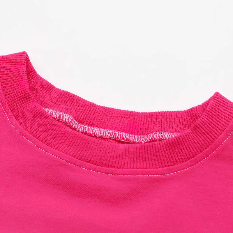 Close-up of the O-neck design on a sports female gradient color crop top, highlighting the vibrant pink shade and ribbed collar.