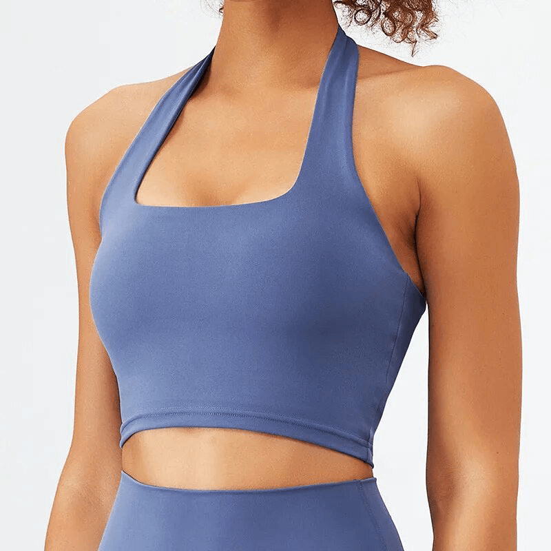 Woman wearing a stylish blue sleeveless sports bra, perfect for yoga or fitness. Part of the SF1766 Sports Fitness Set for women.