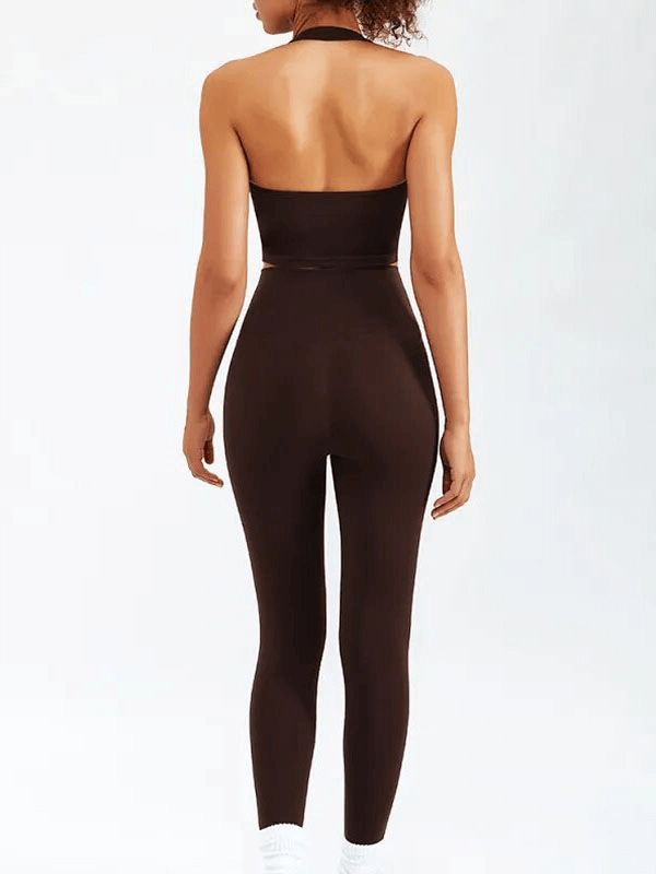 Back view of a woman wearing a sleeveless sports fitness set, perfect for yoga and running, made of breathable nylon fabric.
