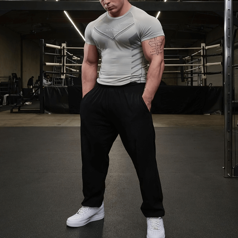 Man wearing Sports Men's Quick Dry T-Shirt in gym, featuring stylish o-neck and short sleeves in solid color, ideal for workouts.