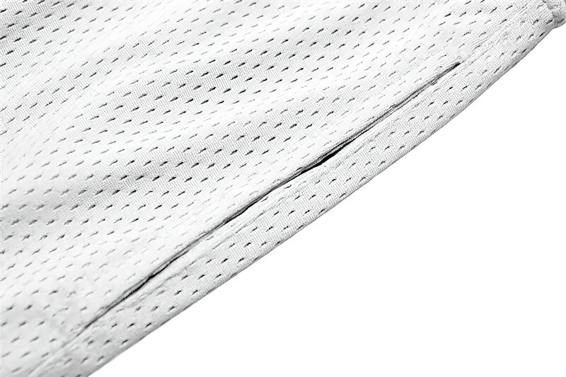 Close-up of white sports mesh material with pocket detail on men's running shorts.