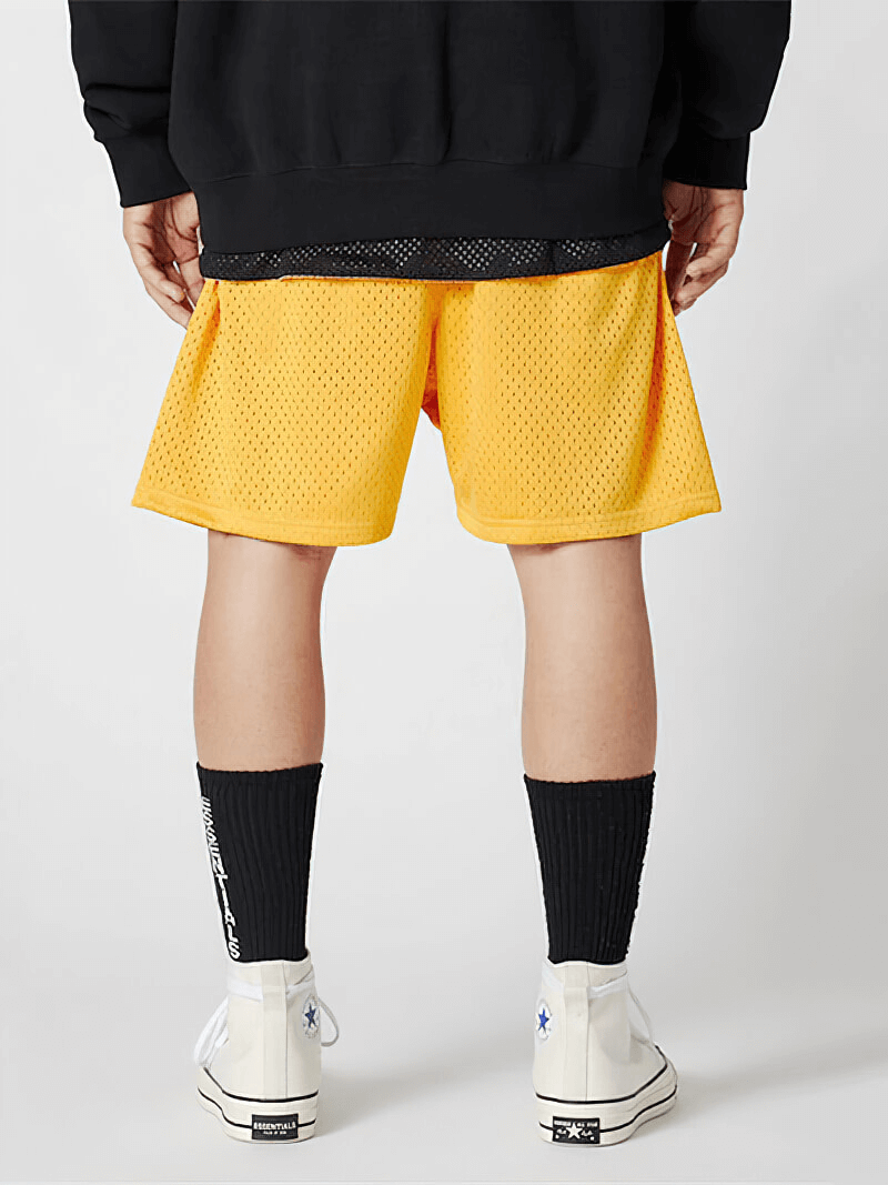 Back view of yellow men's sports mesh running shorts with deep pockets, styled for workouts in breathable polyester mesh.