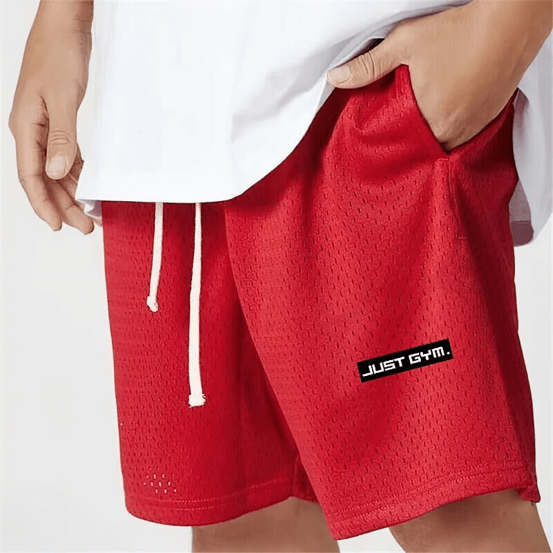 Man wearing red sports mesh short shorts with pockets, ideal for running and gym, featuring "Just Gym" logo on the side.