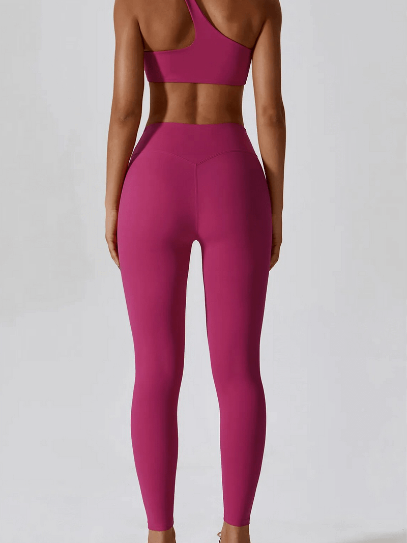Back view of sports one shoulder push-up bra and leggings set in pink for women. Ideal for workouts with lightweight, breathable fabric.
