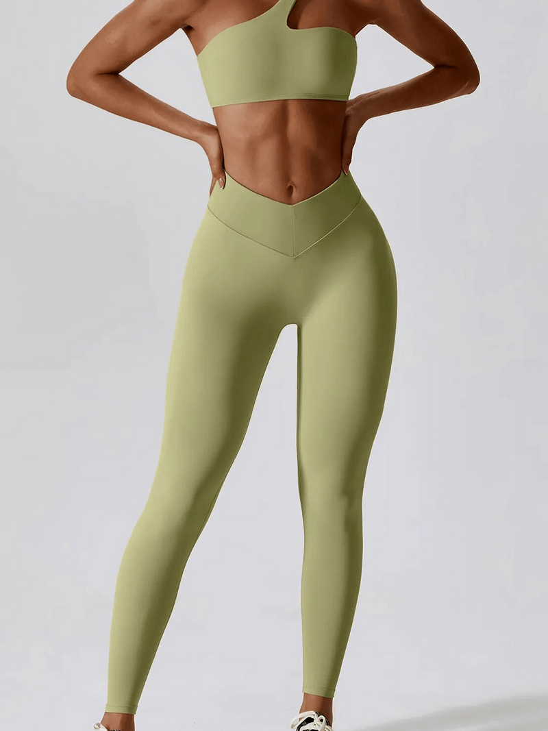 Woman wearing a sports one shoulder push-up bra and leggings set, SF1697; lightweight nylon, slim fit, sleeveless, solid pattern.
