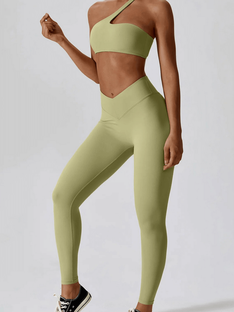 Stylish one shoulder push-up bra and leggings set, ideal for workouts. Lightweight nylon fabric for comfort and mobility. Female sportswear.