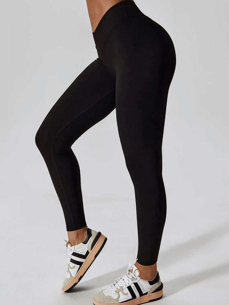 Woman wearing black sports leggings showcasing slim fit style and comfort.