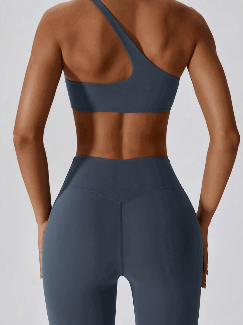 Woman wearing sports one shoulder push-up bra and leggings, SF1697 set, ideal for workouts, breathable fabric, back view