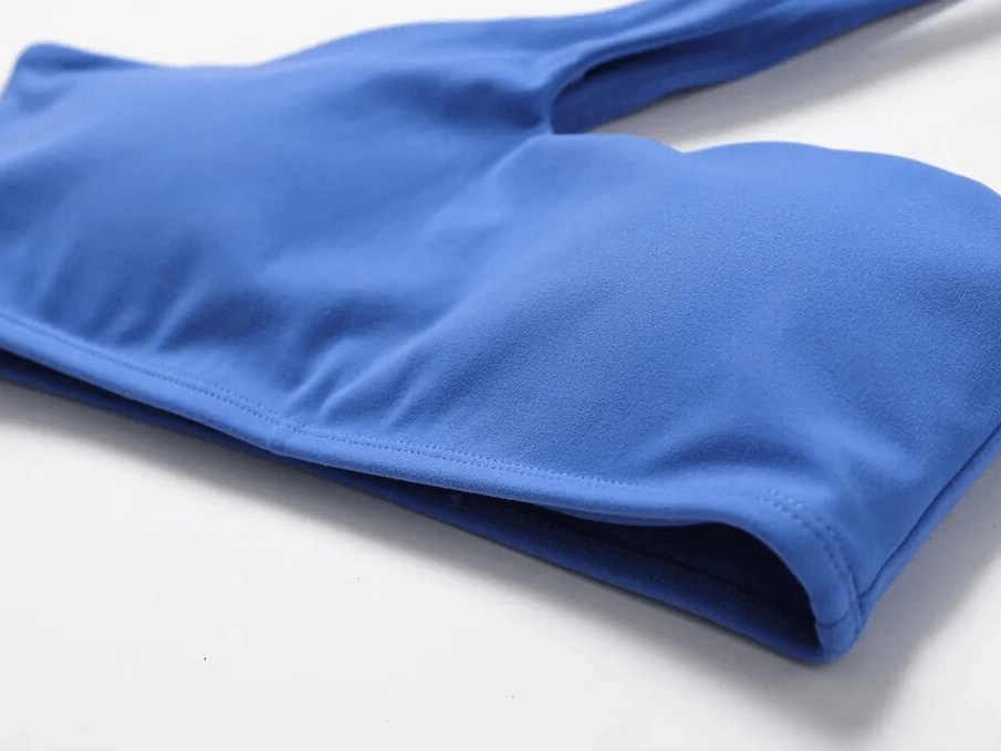 Close-up of blue Sports One Shoulder Push-up Bra showcasing lightweight, breathable nylon fabric, perfect for workouts.