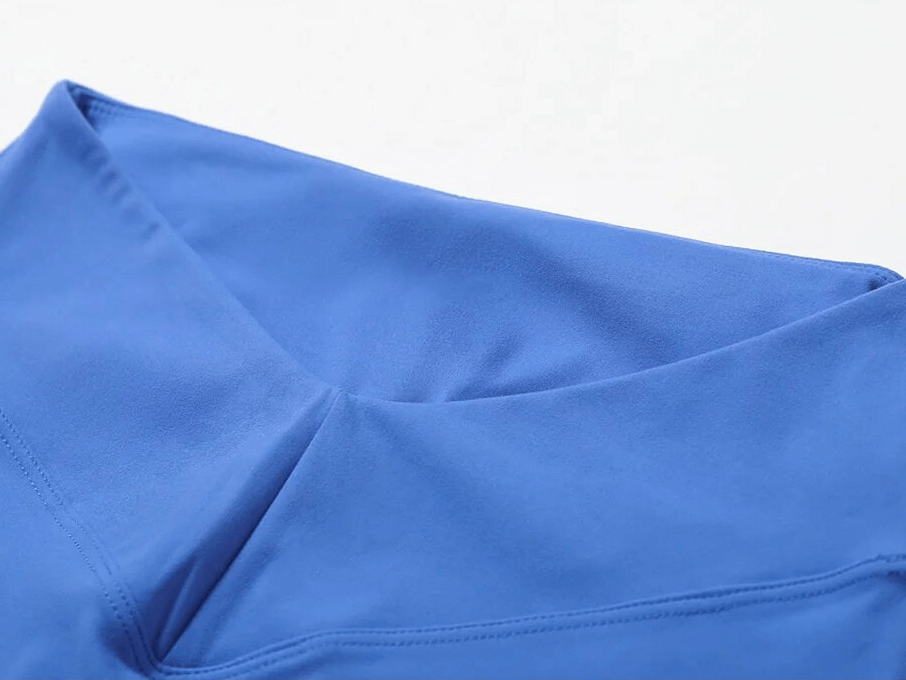 Close-up of blue nylon fabric on the Sports One Shoulder Push-up Bra and Leggings, showcasing breathable material for exercise comfort.